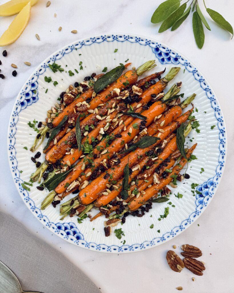 Glazed carrots topped with nuts, dried barberries and crispy sage leaves