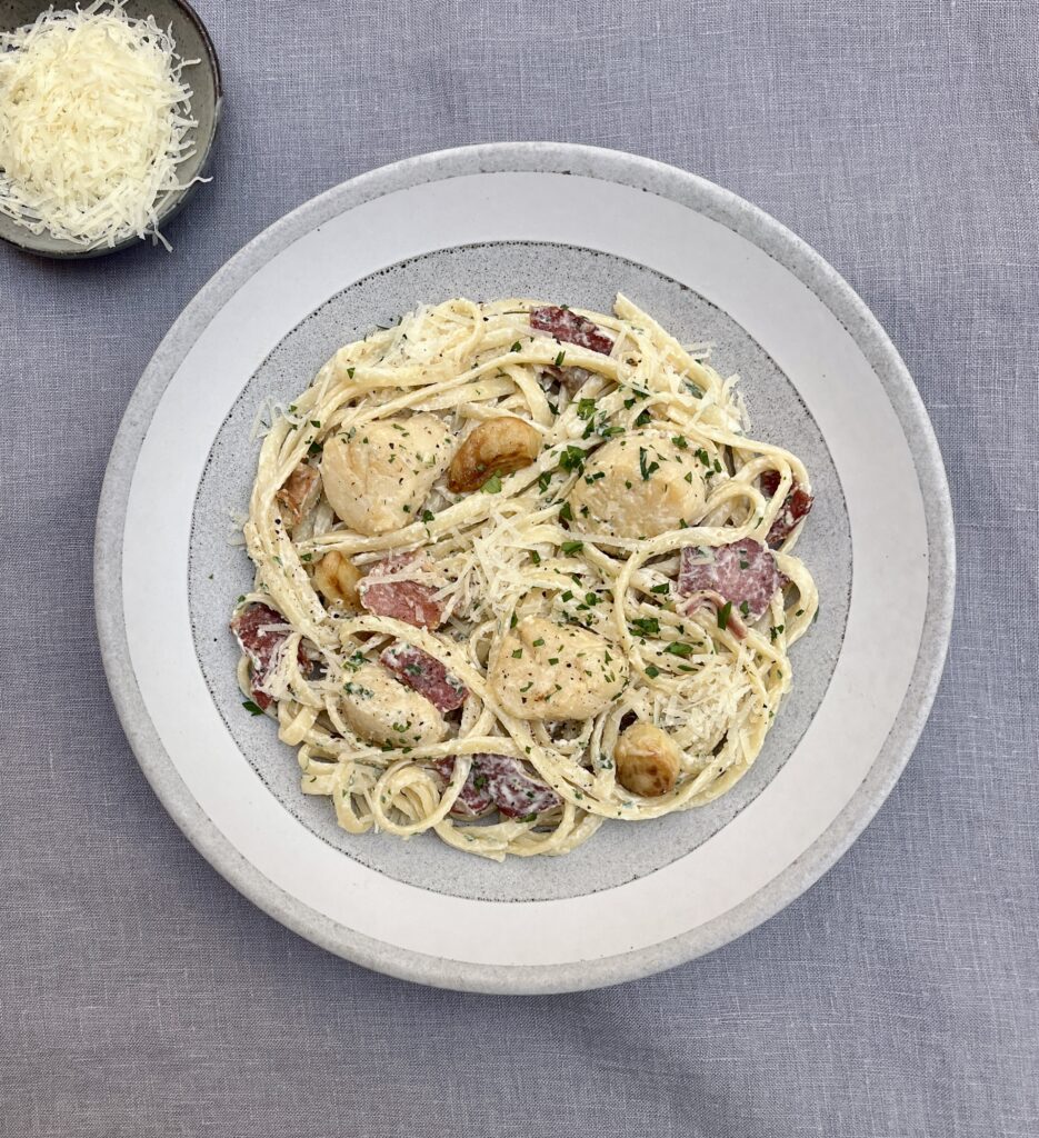 Linguine pasta in a creamy sauce with scallops and bacon, parmesan and parsley