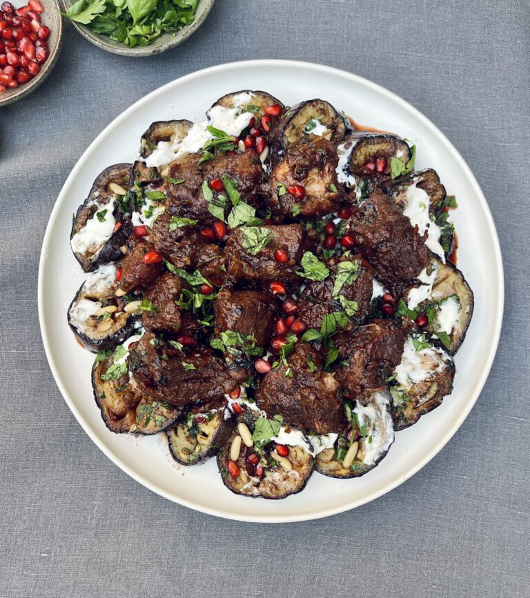 braised veal over sliced eggplant and burrata topped with fresh herbs and pomegranate jewels