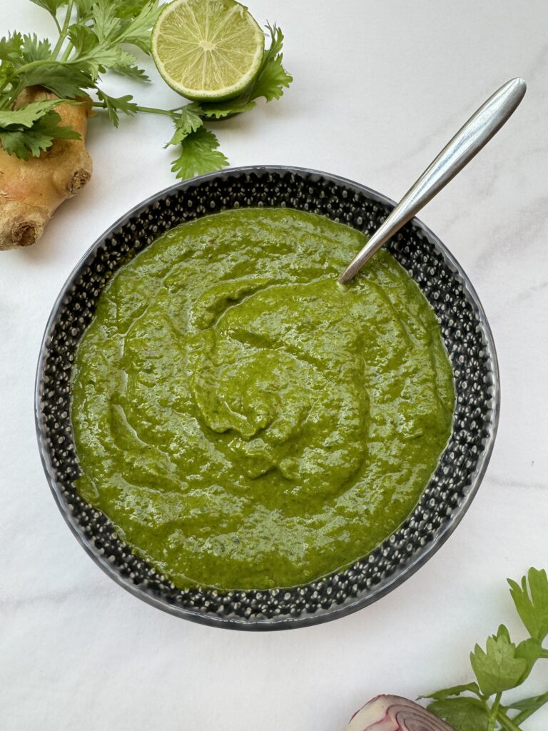 Thick and smooth green sauce in a dark grey bowl