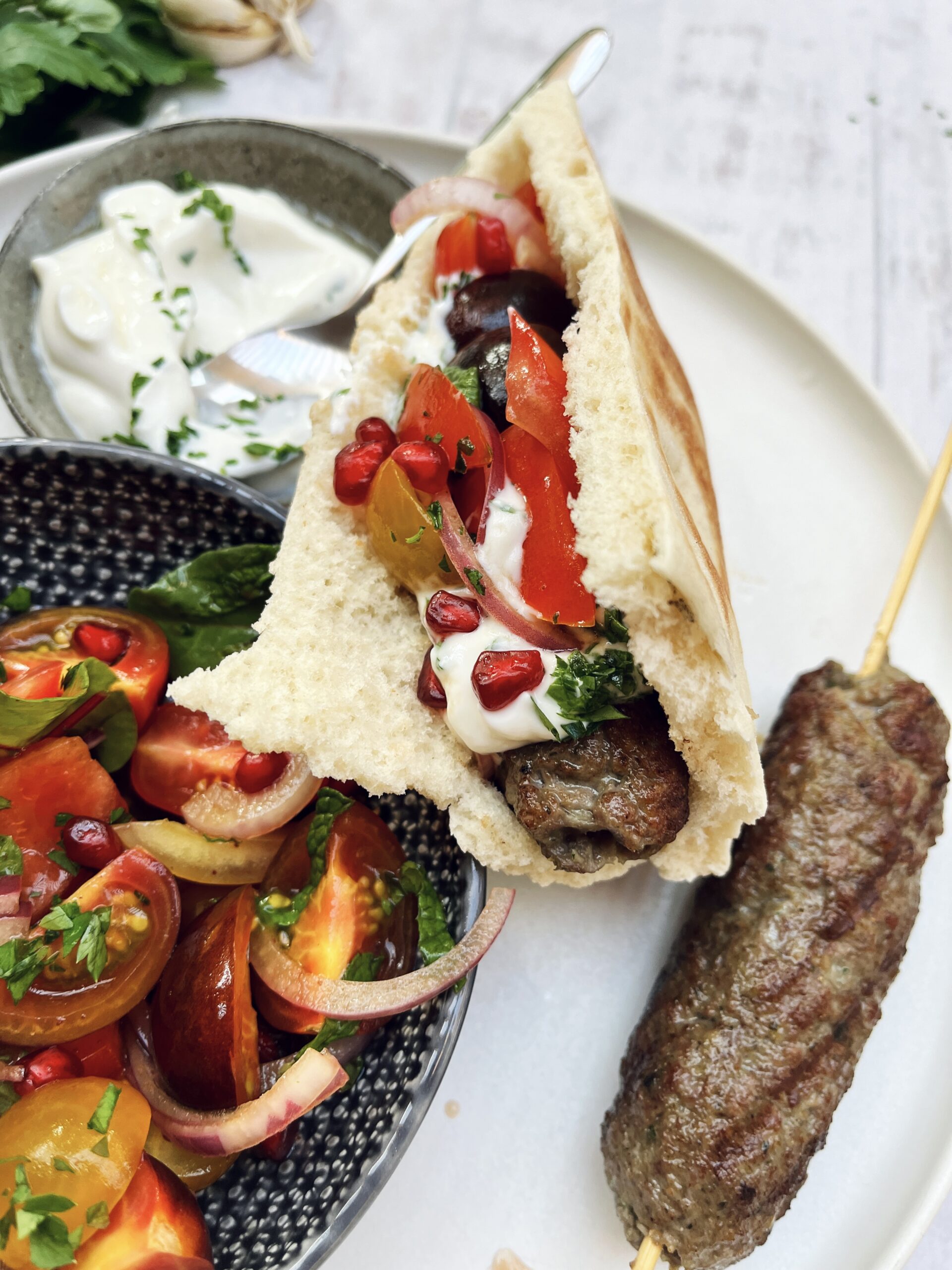 Pita bread stuffed with meat kofta, yoghurt and a fresh salad