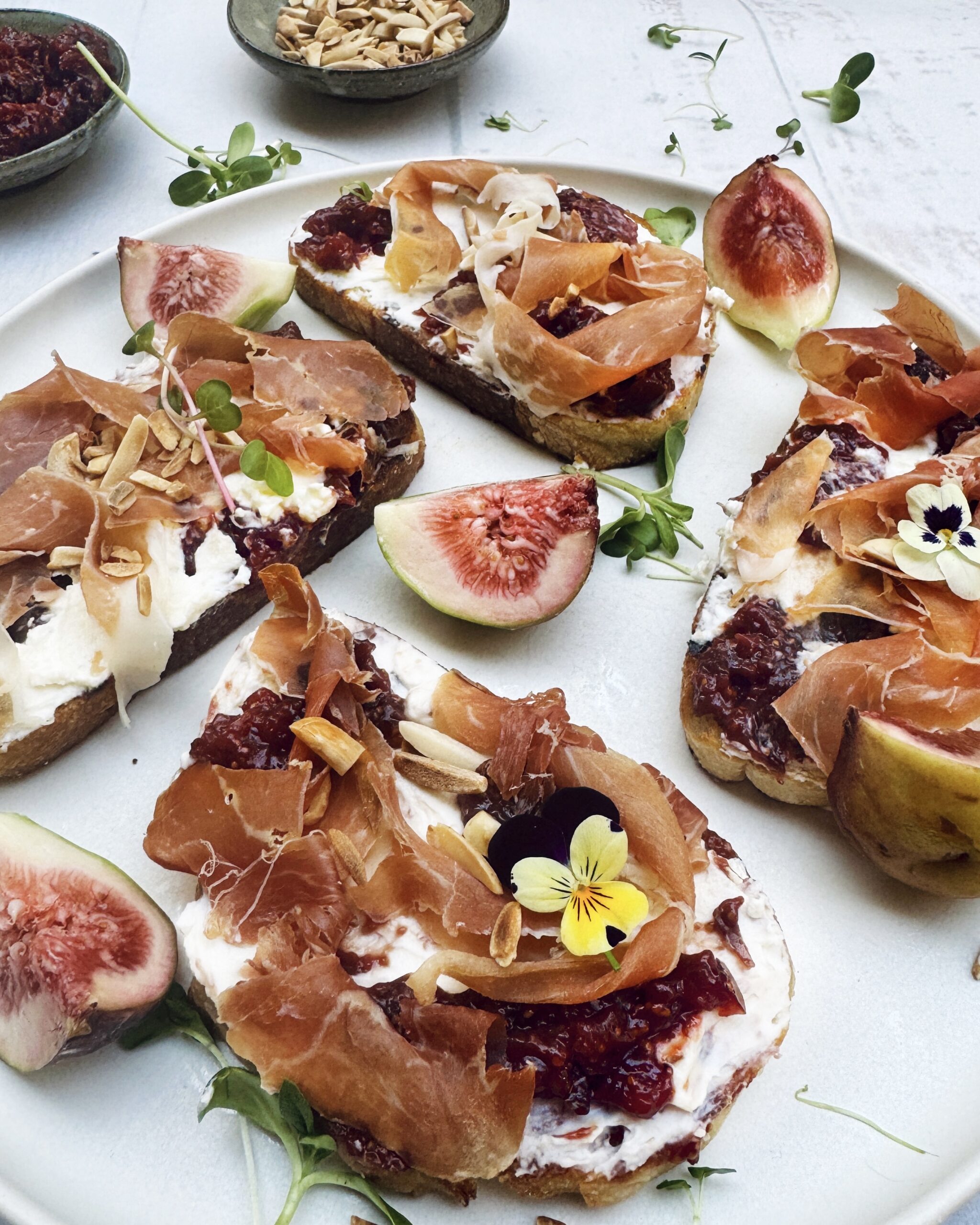 grilled sourdough bread with whipped mascarpone, fig chutney, prosciutto and toasted almonds