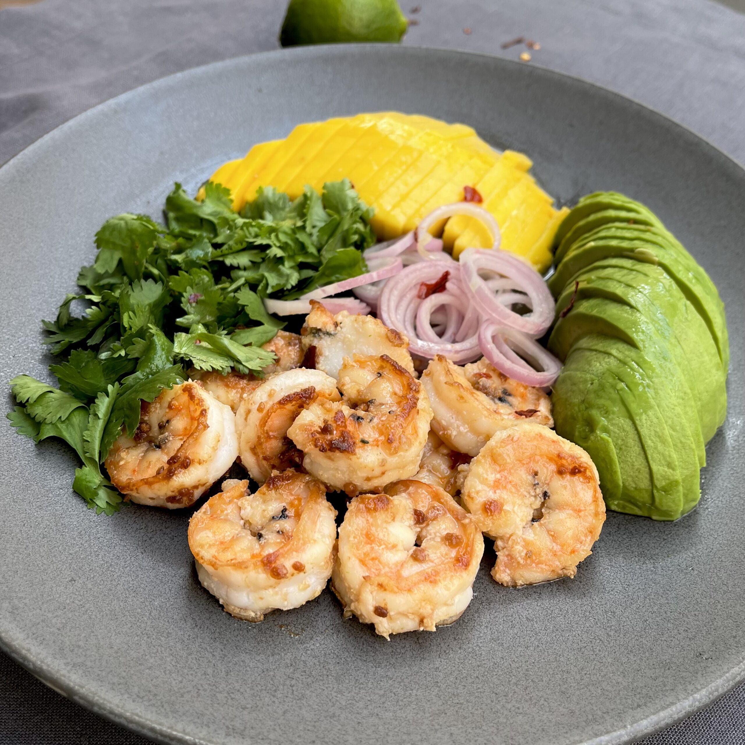 Fried prawns, mango and avocado salad with coriander and lime dressing