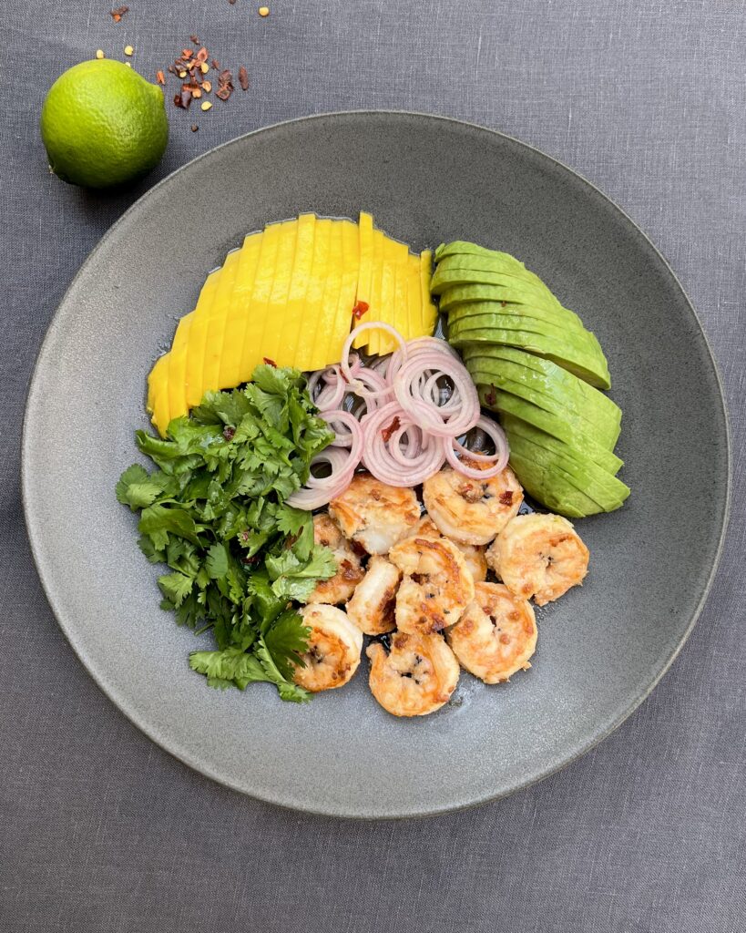 Fried prawns, mango and avocado salad with coriander and lime dressing