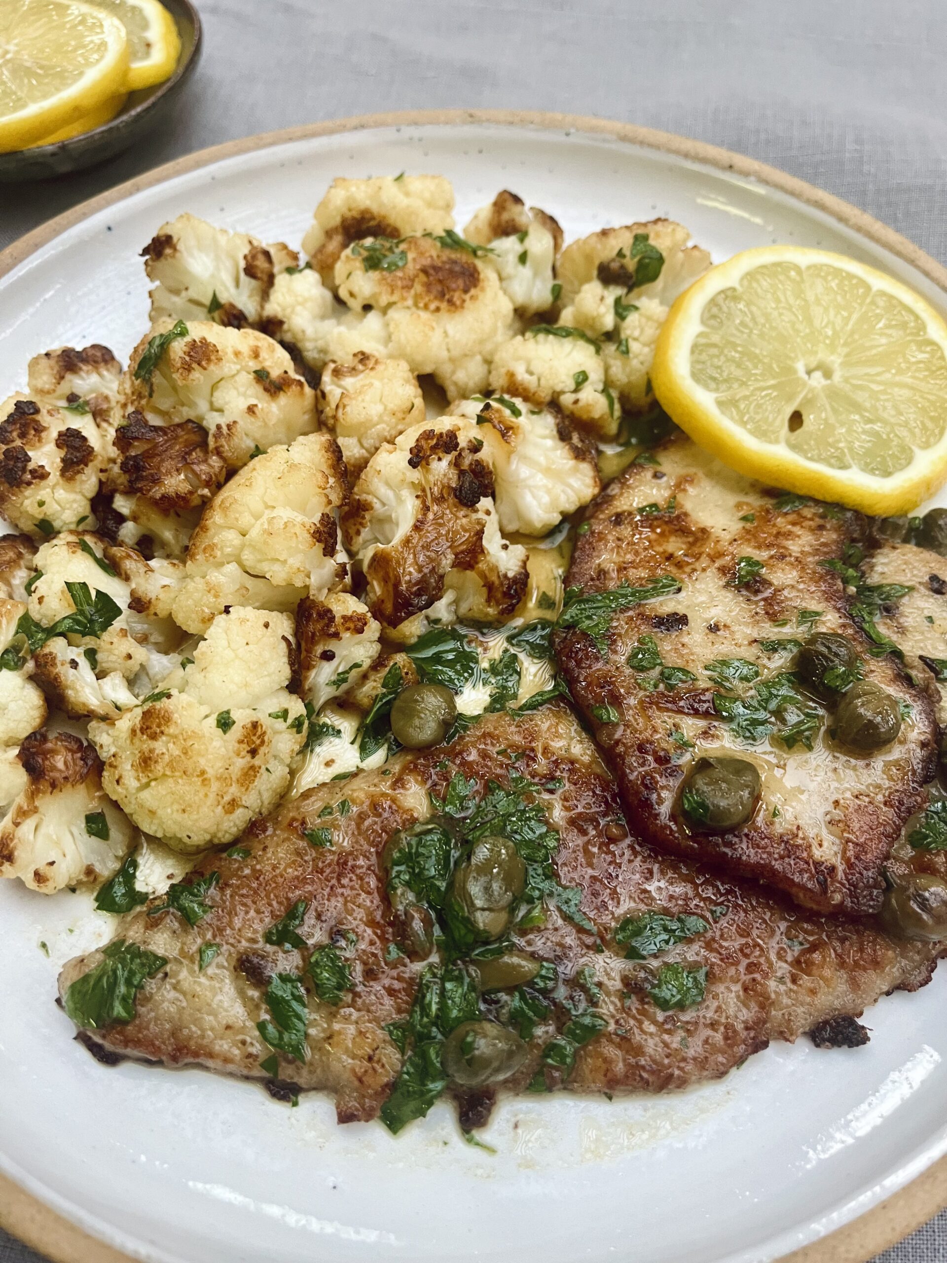 veal piccata - lightly breaded fried veal escalops with lemon, parsley and capers served alongside fried cauliflower.