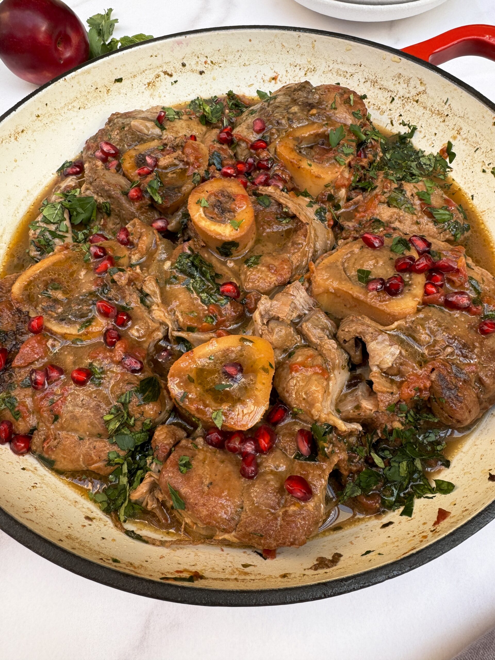 braised veal shanks in red sauce made with tkemali and tomatoes