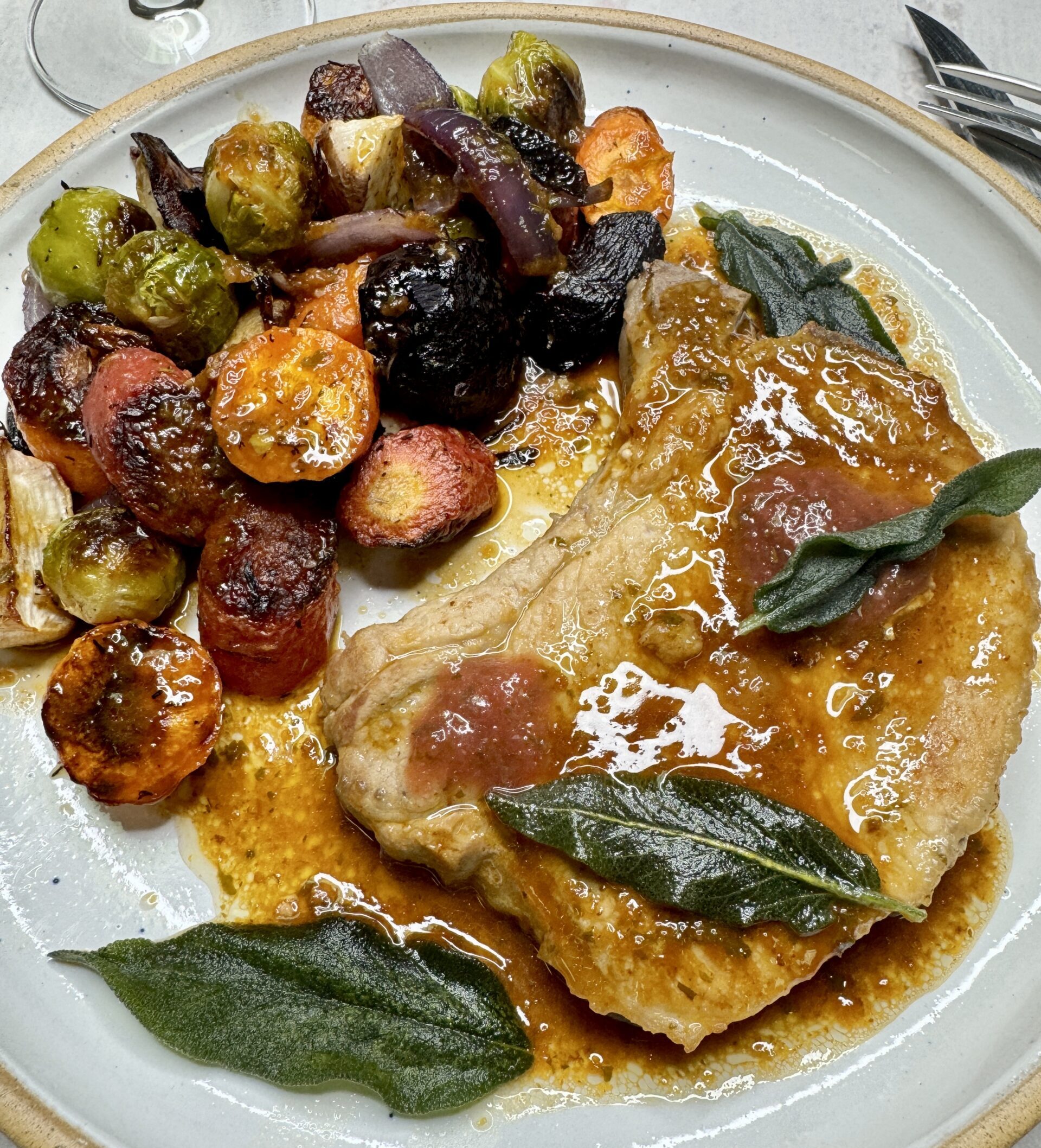 Fried Pork chop with brown gravy, crispy sage leaves and roasted vegetables