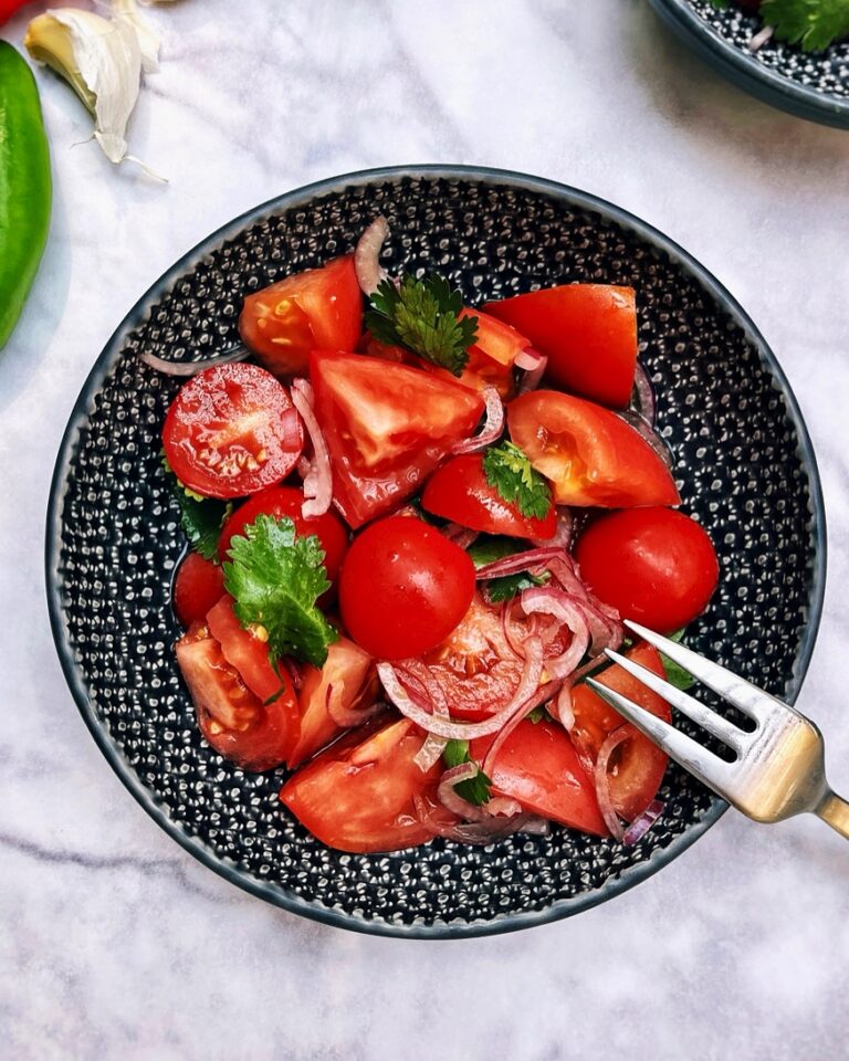 Tomato ceviche with lime, ginger and soy dressing, garnished with red onion and cilantro