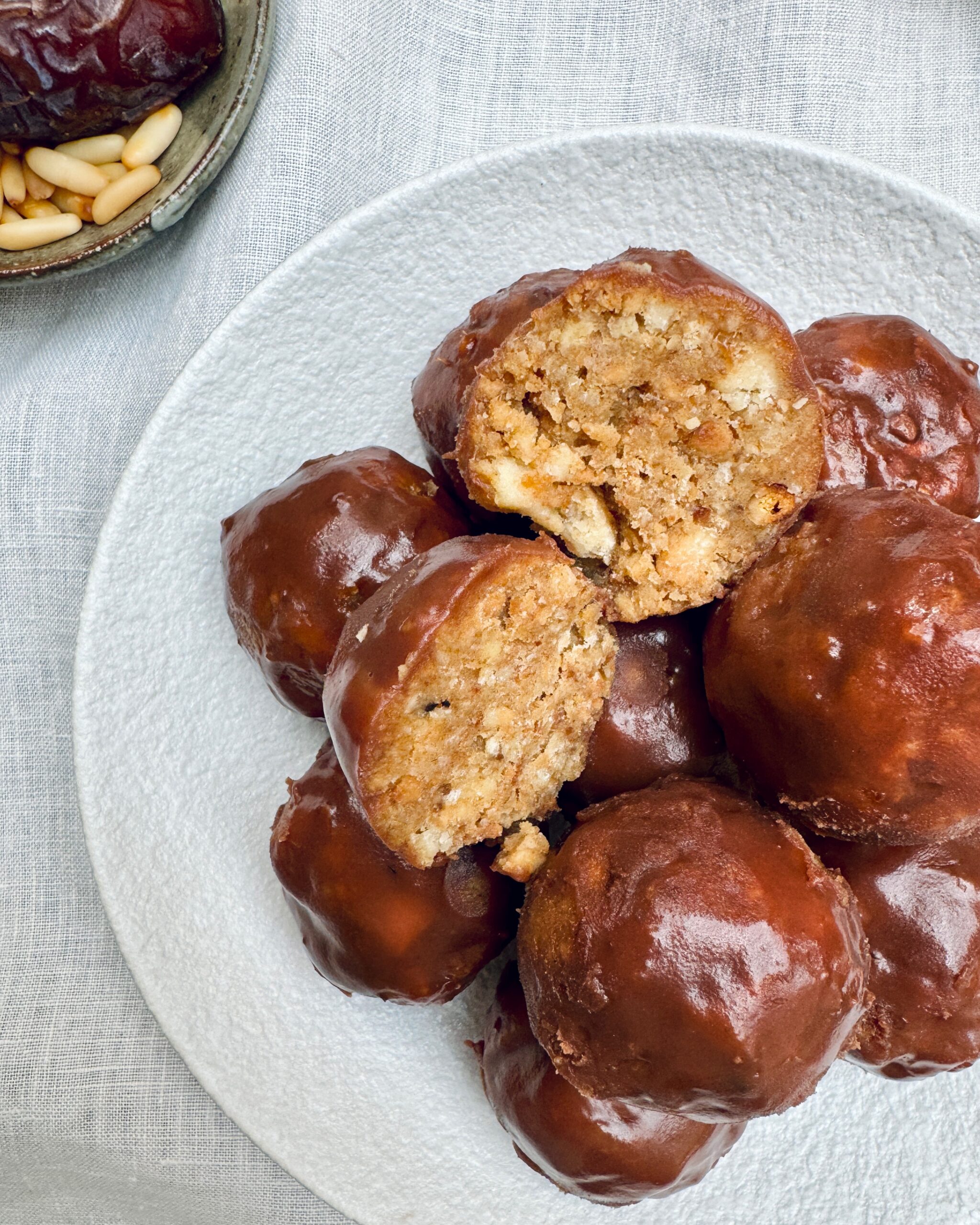 Chocilate coated mini cakes with dates, banana, apple, cardamom and pine nuts