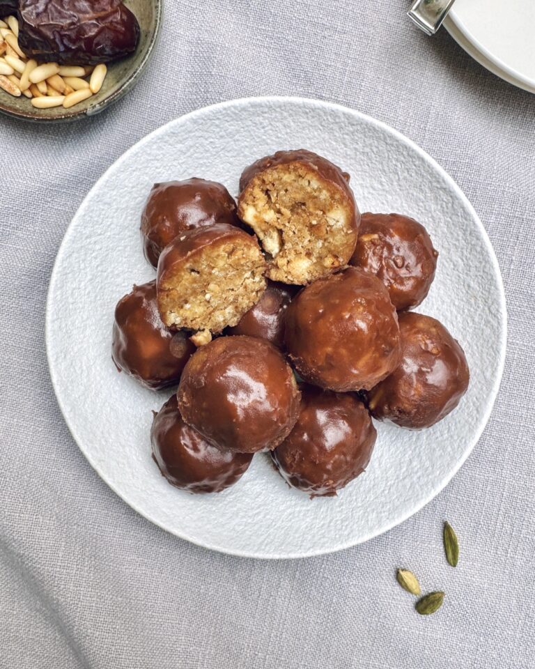 chocolate coated mini round cakes with dates, banana, cardamom, apple and pine nuts