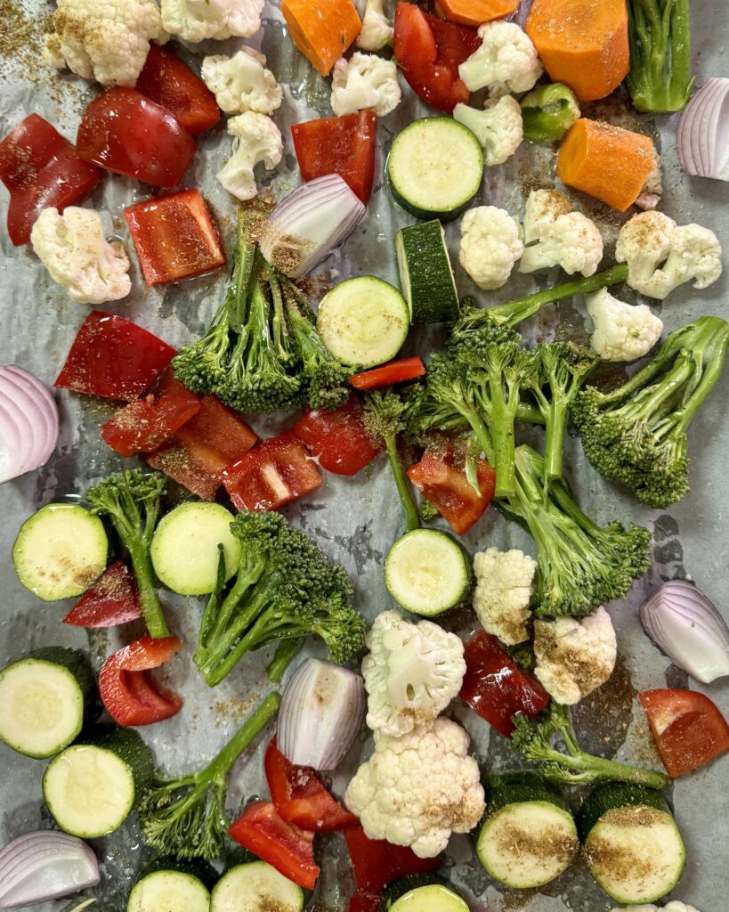 a roasting tray with colorful mixed cut vegetables 