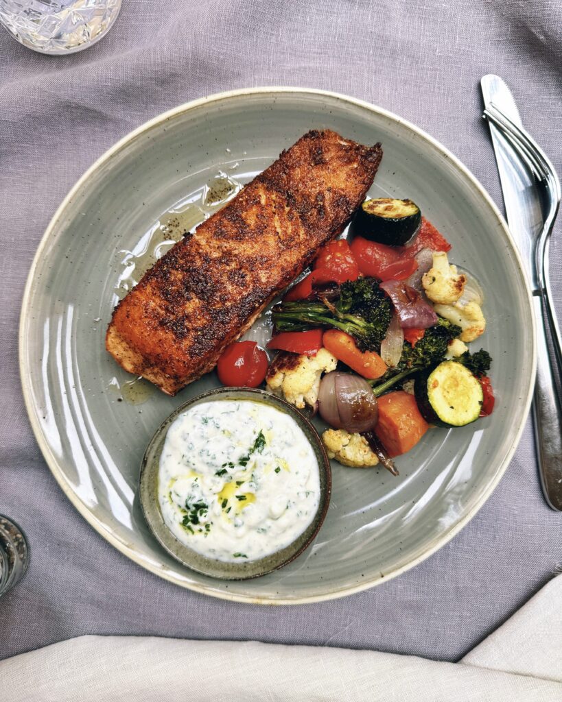 Salmon fillet in baharat spice crust with yoghurt and roasted vegetables