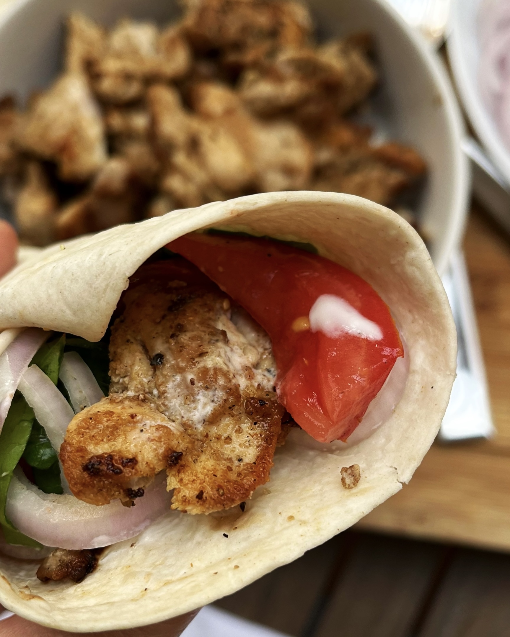 chicken shawarma wrap with fresh tomatoes, red onions and lettuce