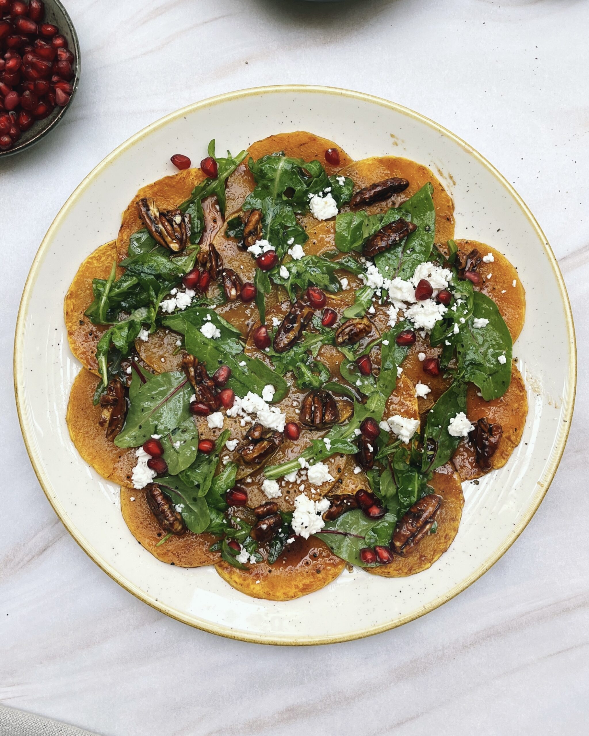 Butternut carpaccio - thinly spiced butternut brushed with an apple glaze and toped with feta, candied pecans, micro greens and pomegranate jewels