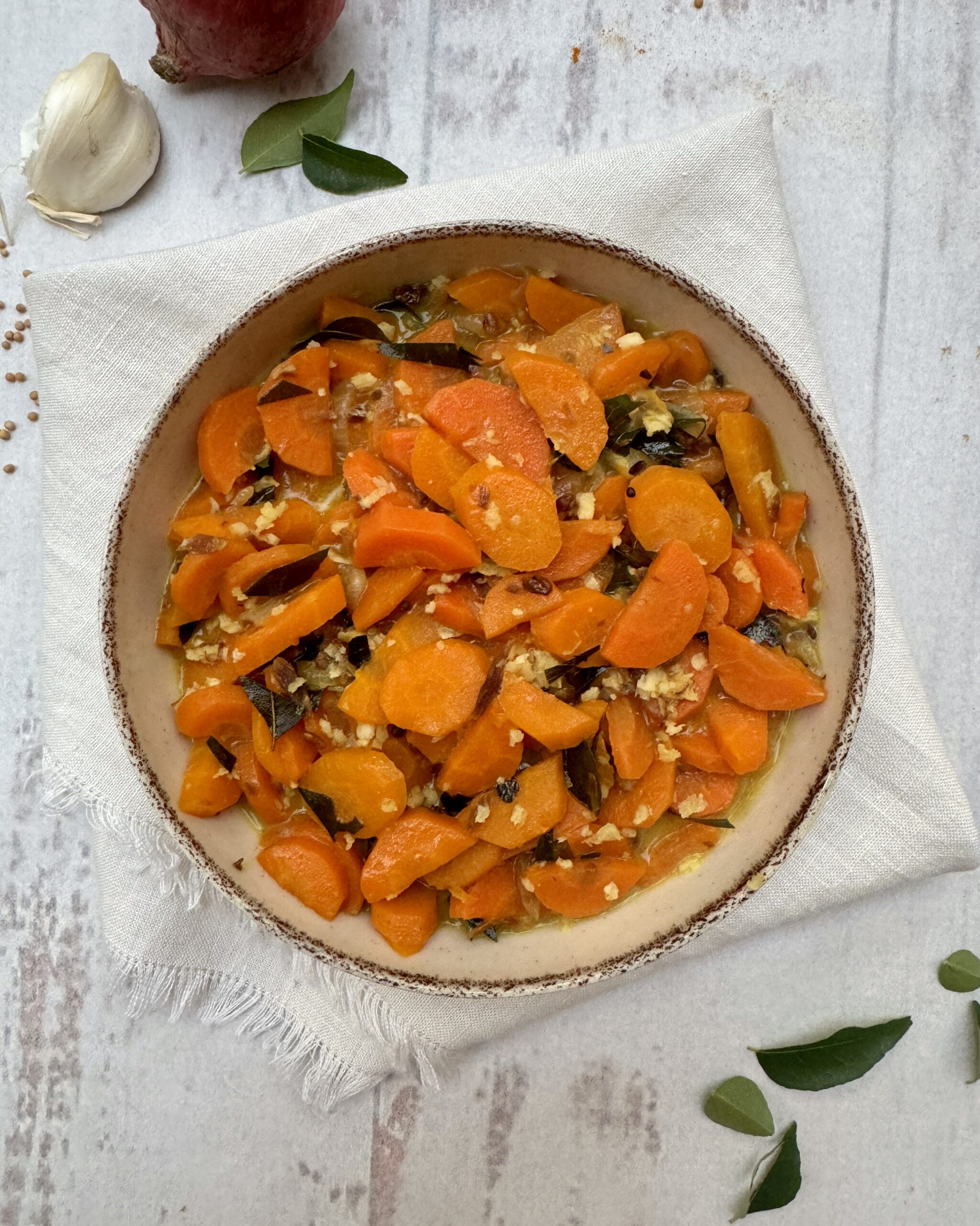 Carrot curry in a rich coconut sauce with aromatics and grated coconut