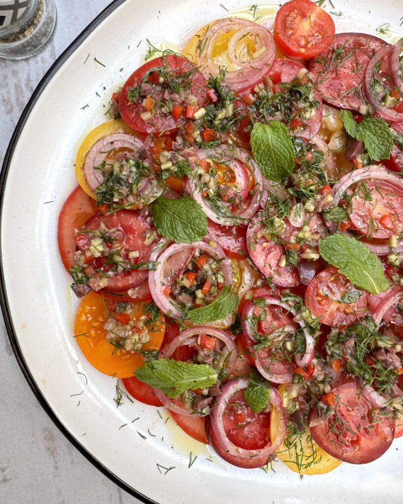 Tomato carpaccio with red onion rings and vegetable salsa