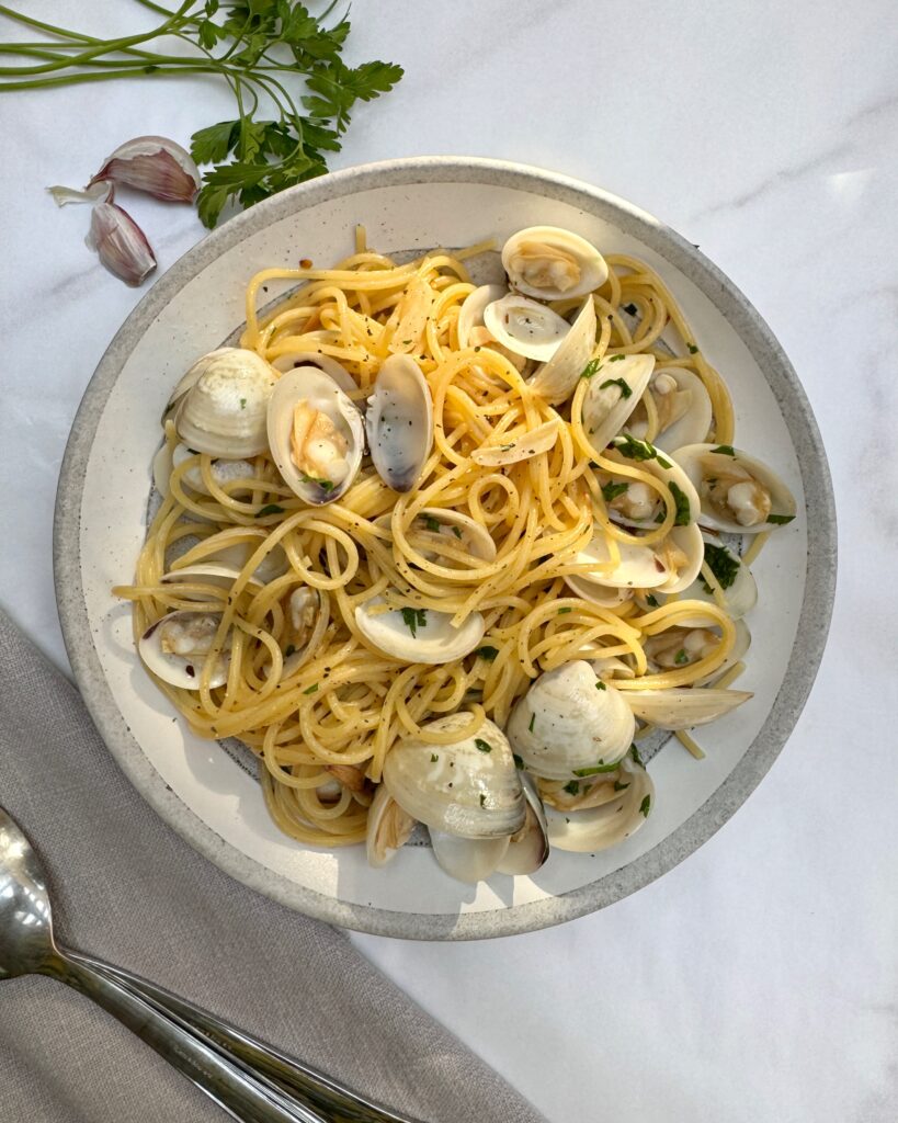 a plate with Spaghetti Alle Vongole, spaghetti pasta with clams