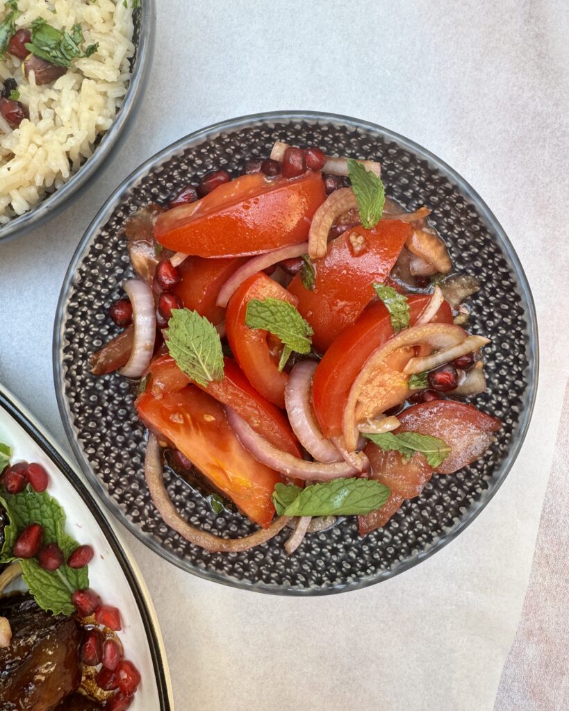 sliced tomatoes with marinated onions