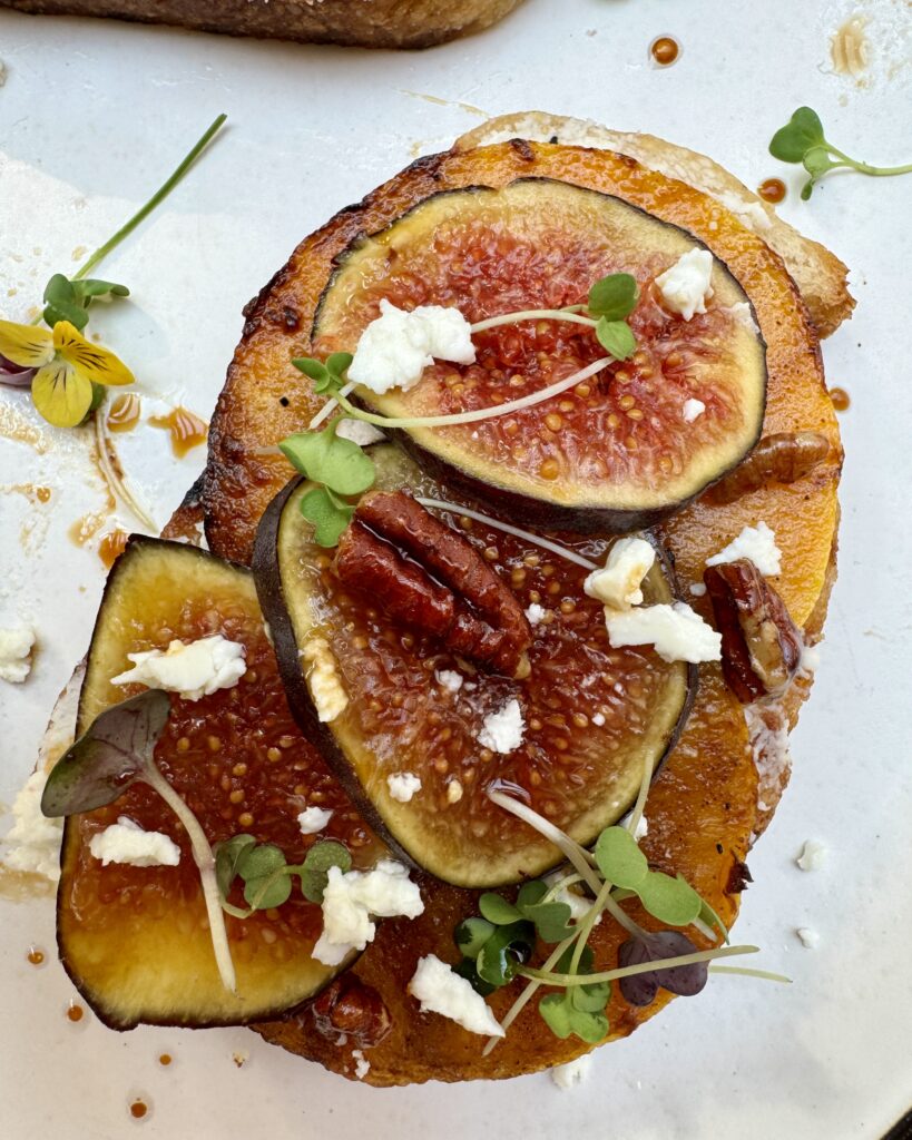 a close up on a grilled sourdough toast with butternut squash, figs and feta