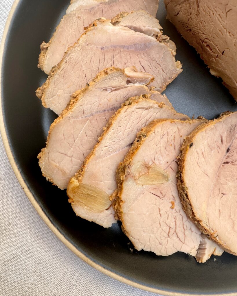 Slices of cold pork roast on a plate