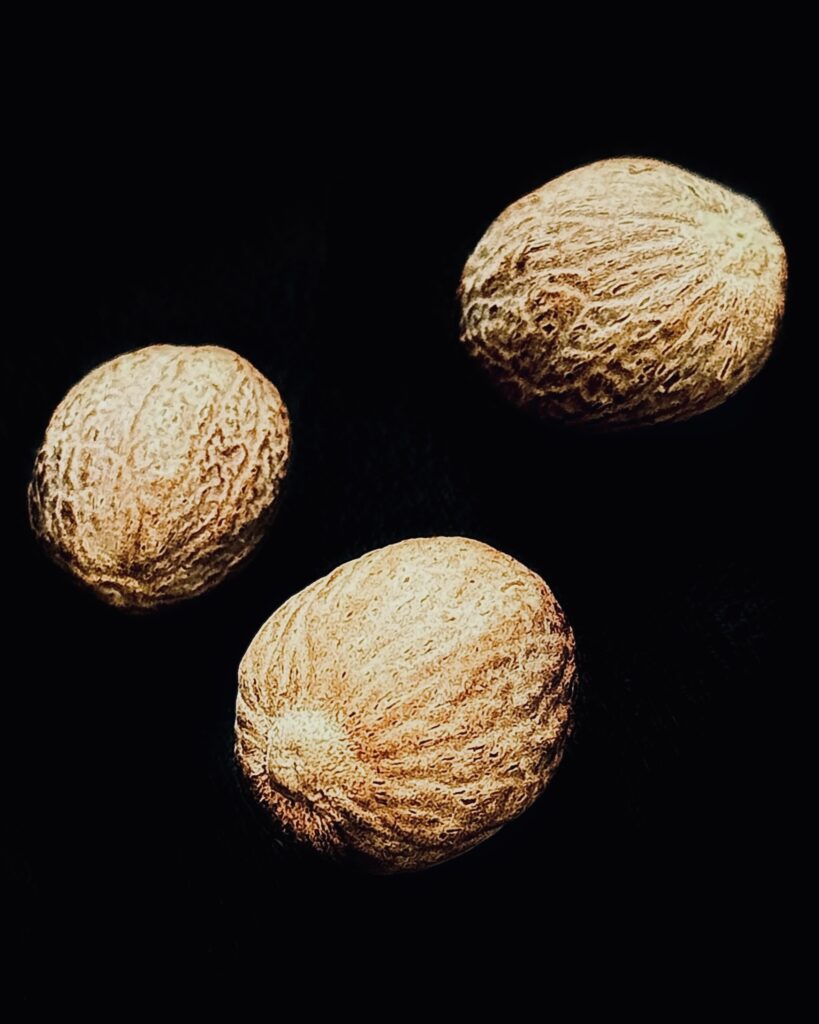 an arty image of nutmeg against black background