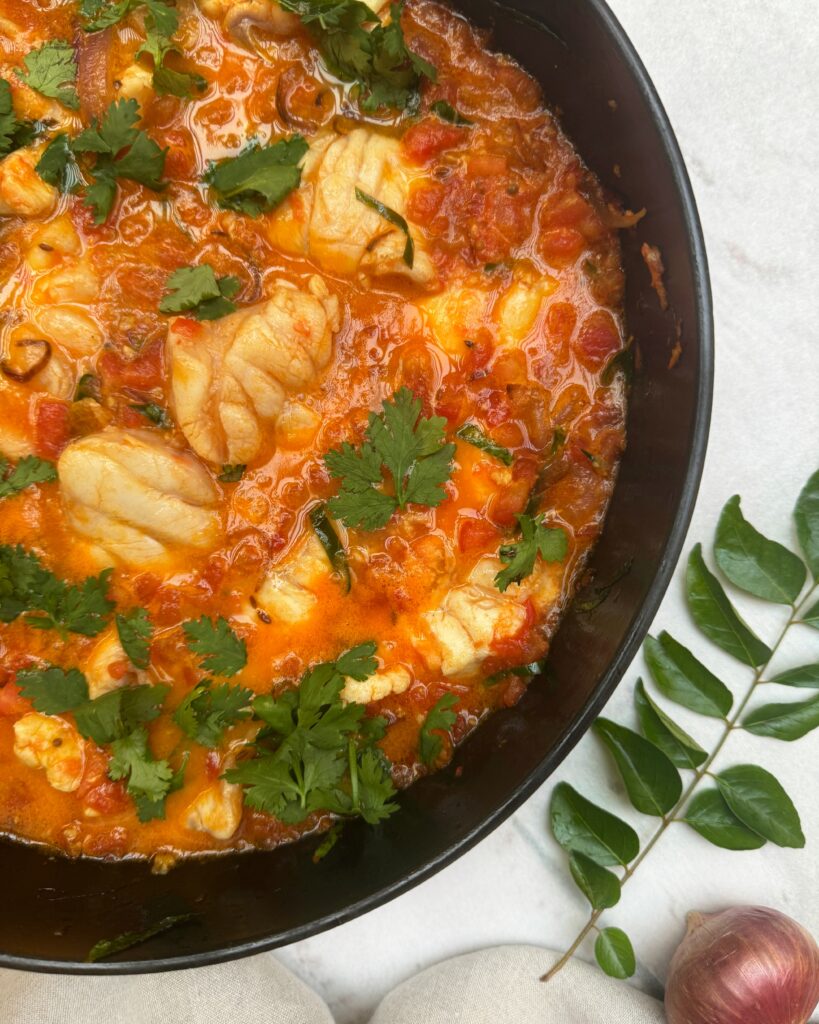 white fish stew in tomato sauce with aromatics and spices