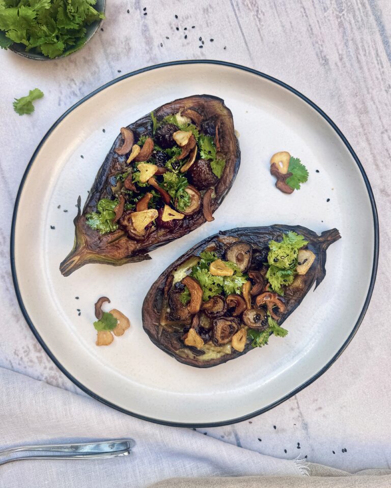 Eggplant halves stuffed with a mixture of garlic chips, shiitake and coriander with sesame truffle dressing